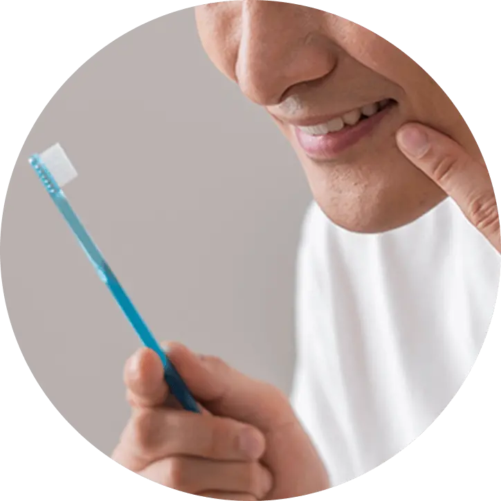 歯ブラシを持った男性が笑っている画像